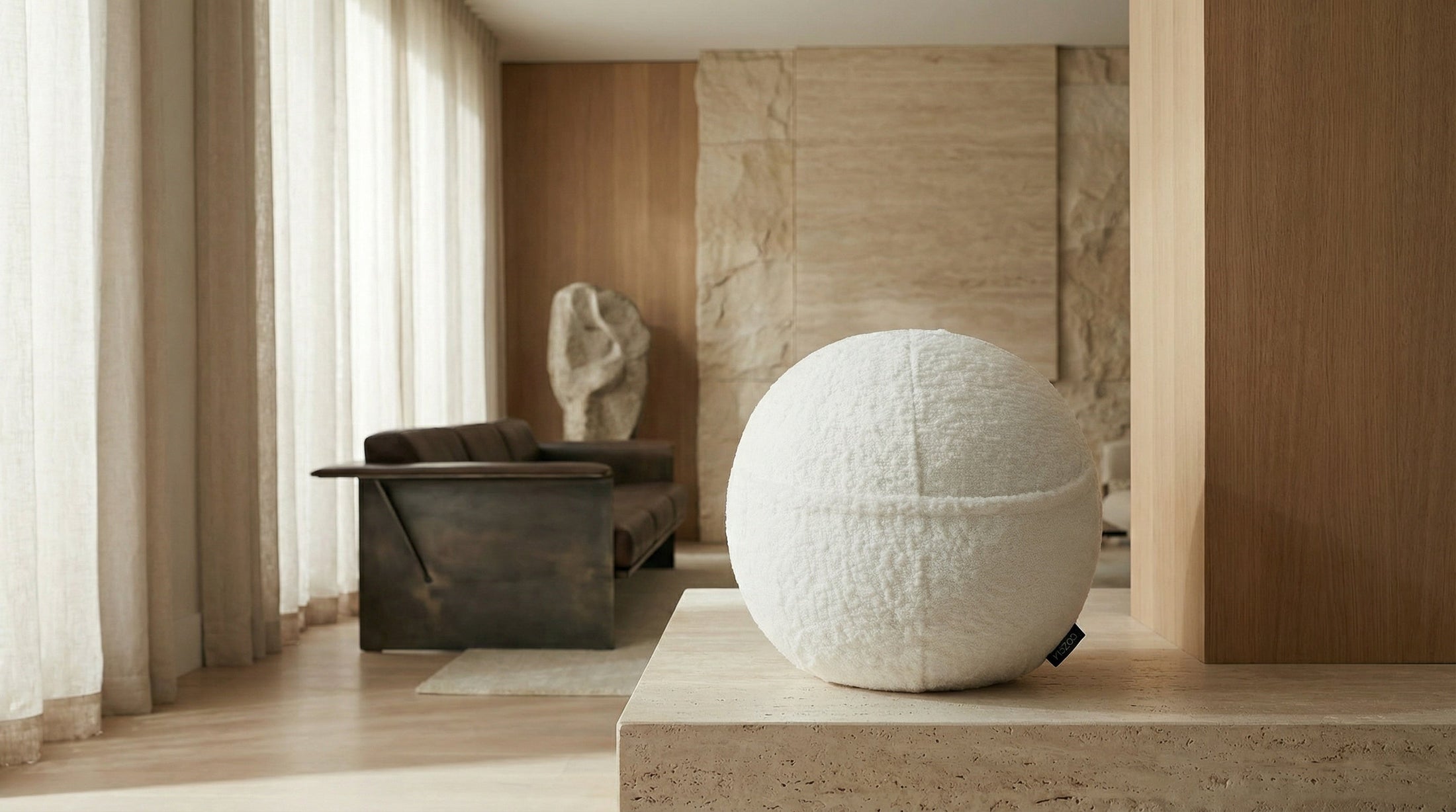 The COZELA Orb bouclé sphere pillow on a countertop